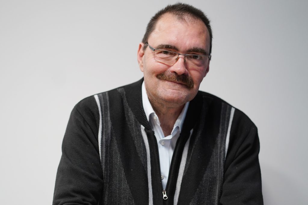 Portrait of man with a plain background.